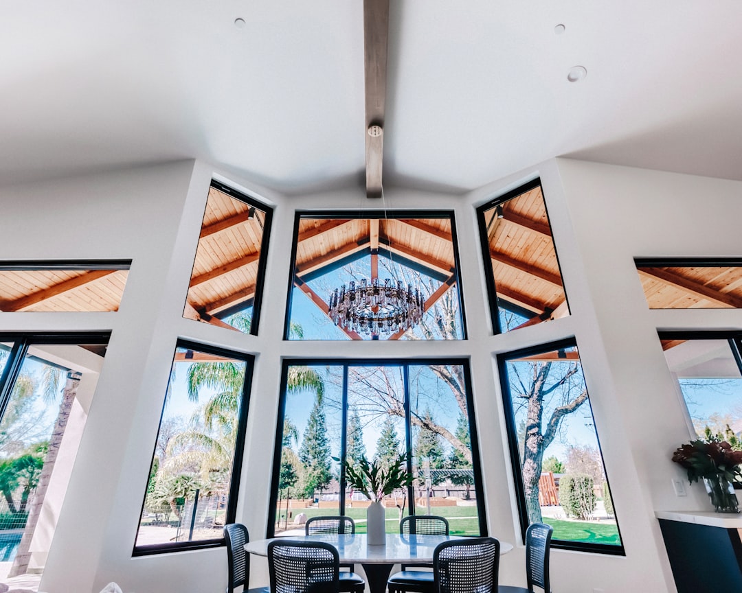 interior view of a modern home with large windows and a chandelier